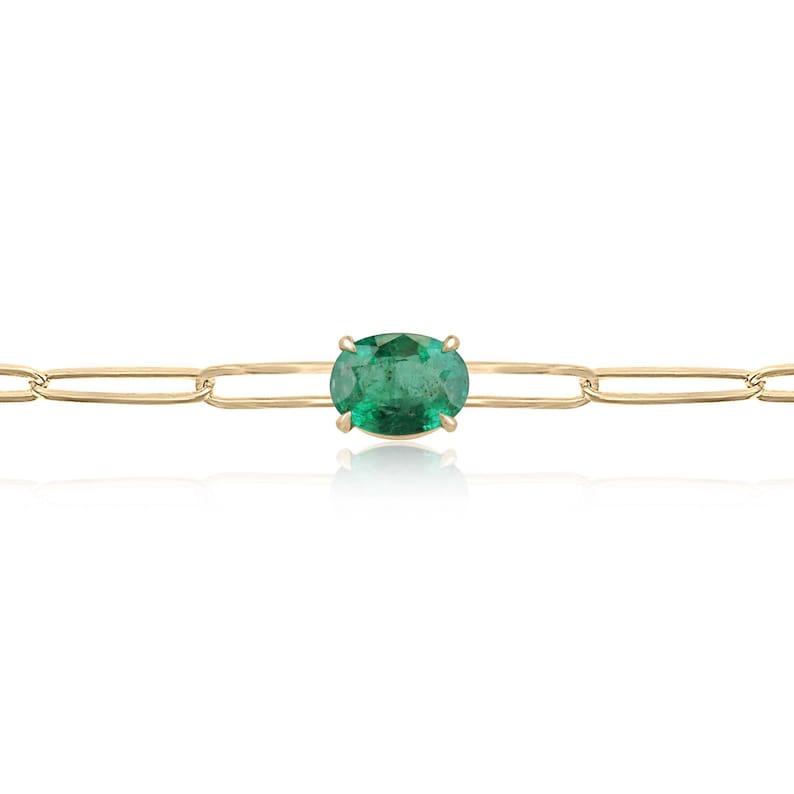 Colombian Emerald bracelet with 2.65ct oval cut green emerald in 14K gold, featuring a paperclip design and four-prong setting.