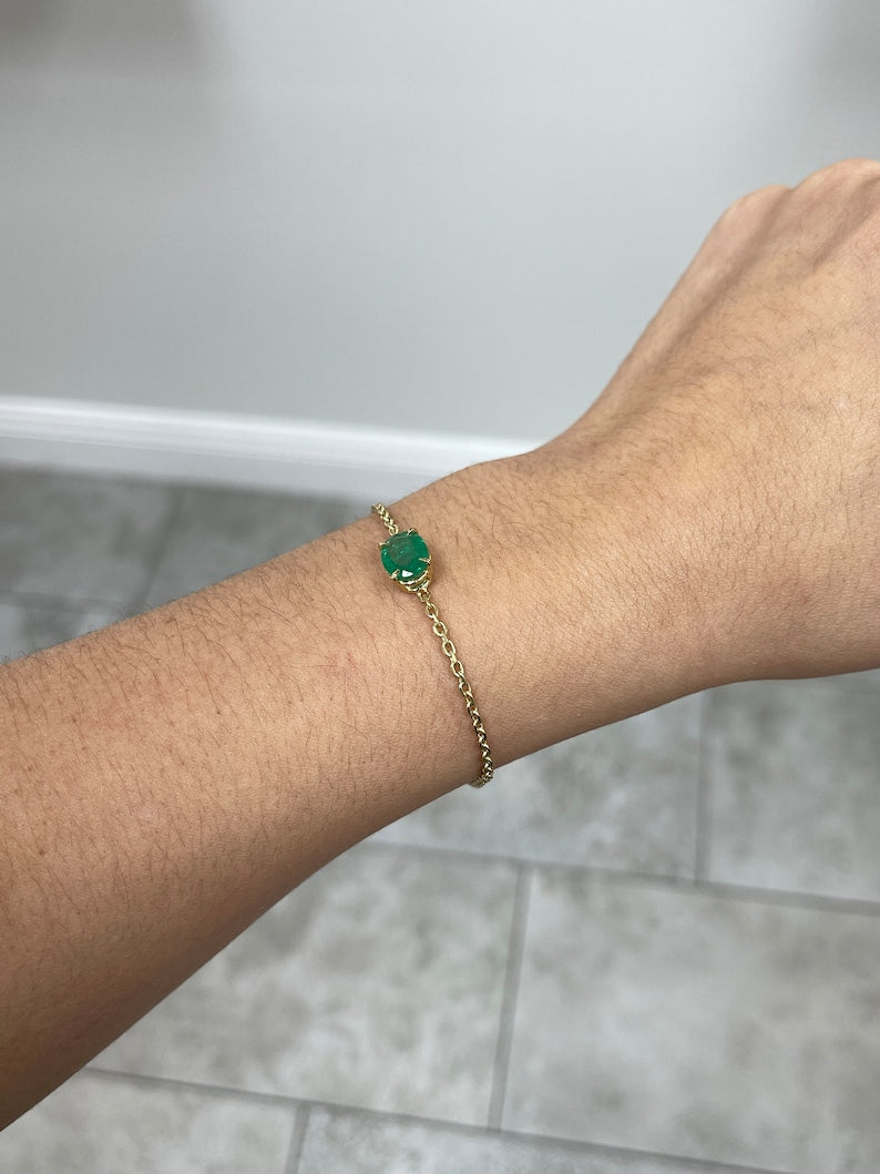 Colombian Emerald 2.0ct unisex 14K gold bracelet featuring a vivid medium dark green oval cut emerald in a four-prong setting.