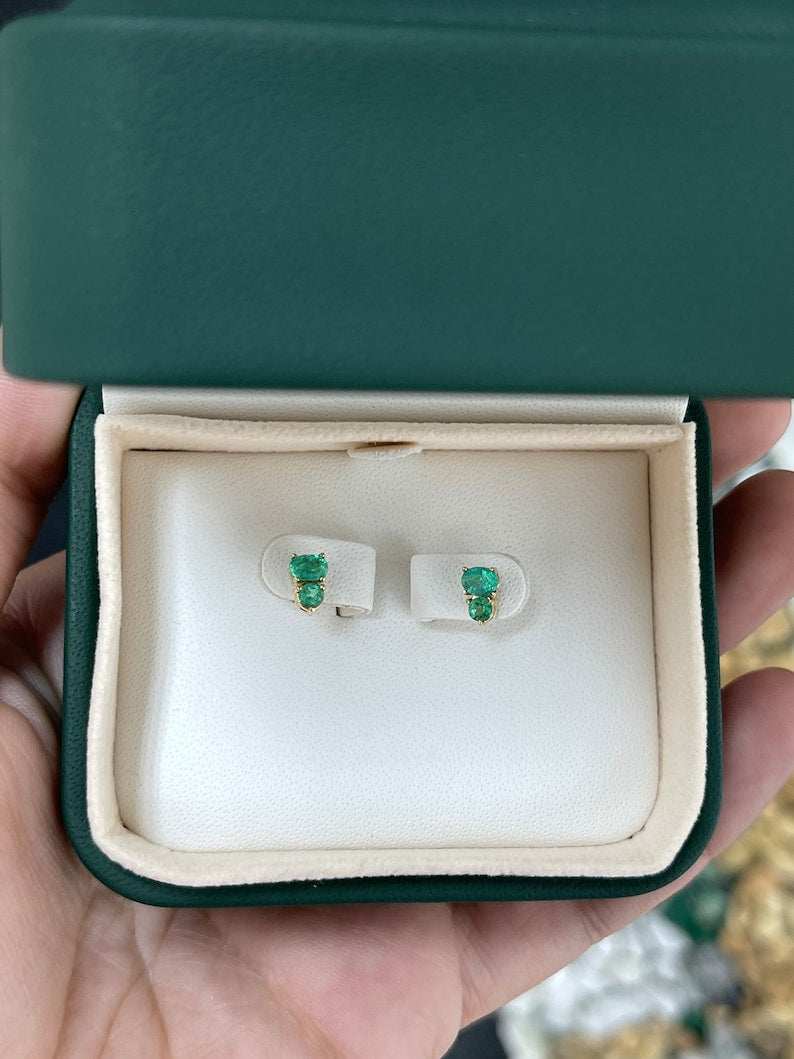 Colombian Emerald 14K yellow gold stud earrings featuring petite green oval and round cut emeralds, 0.45tcw.