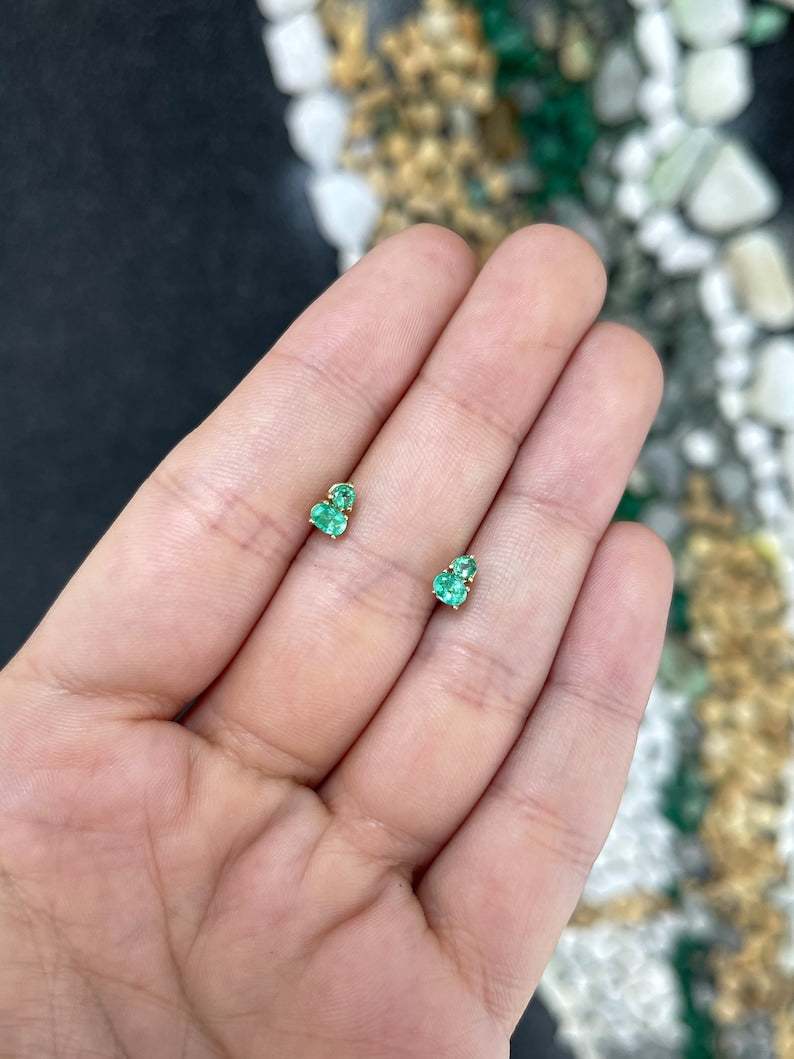 14K gold emerald stud earrings with petite oval and round cut green emeralds, featuring 0.45 carats total weight.