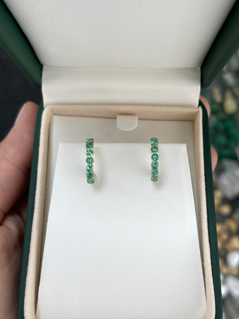 Colombian Emerald 14K yellow gold half hoop earrings with round cut green emeralds, prong set, 1.50 tcw, huggie style.
