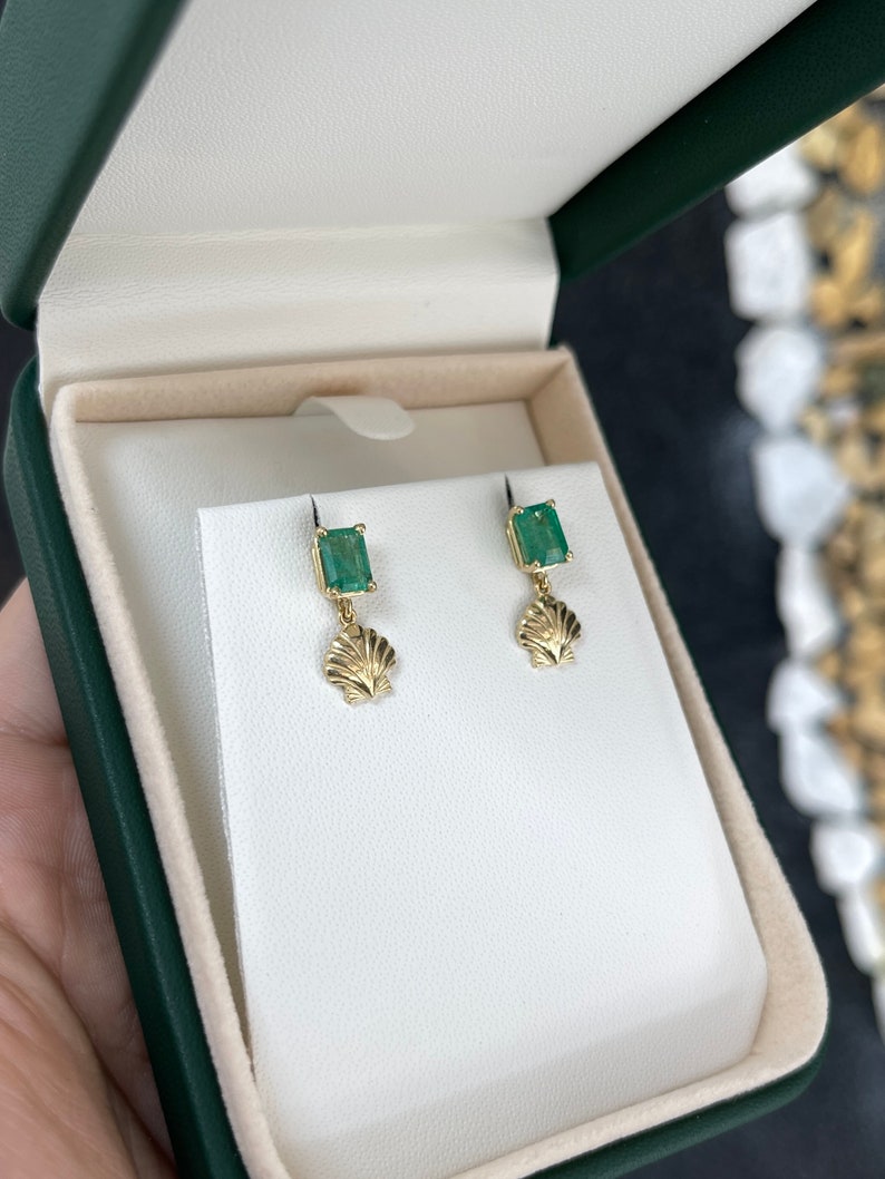 Colombian Emerald gold dangle stud earrings featuring sea shell design in 14K yellow gold with 1.90 carats of emeralds