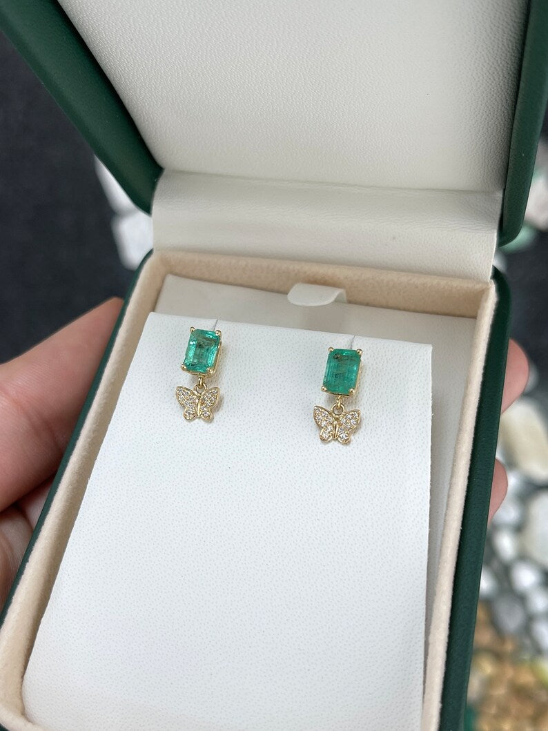 14K gold butterfly dangle earrings with natural emeralds and diamonds, featuring a 2.40tcw design from Colombian Emerald.