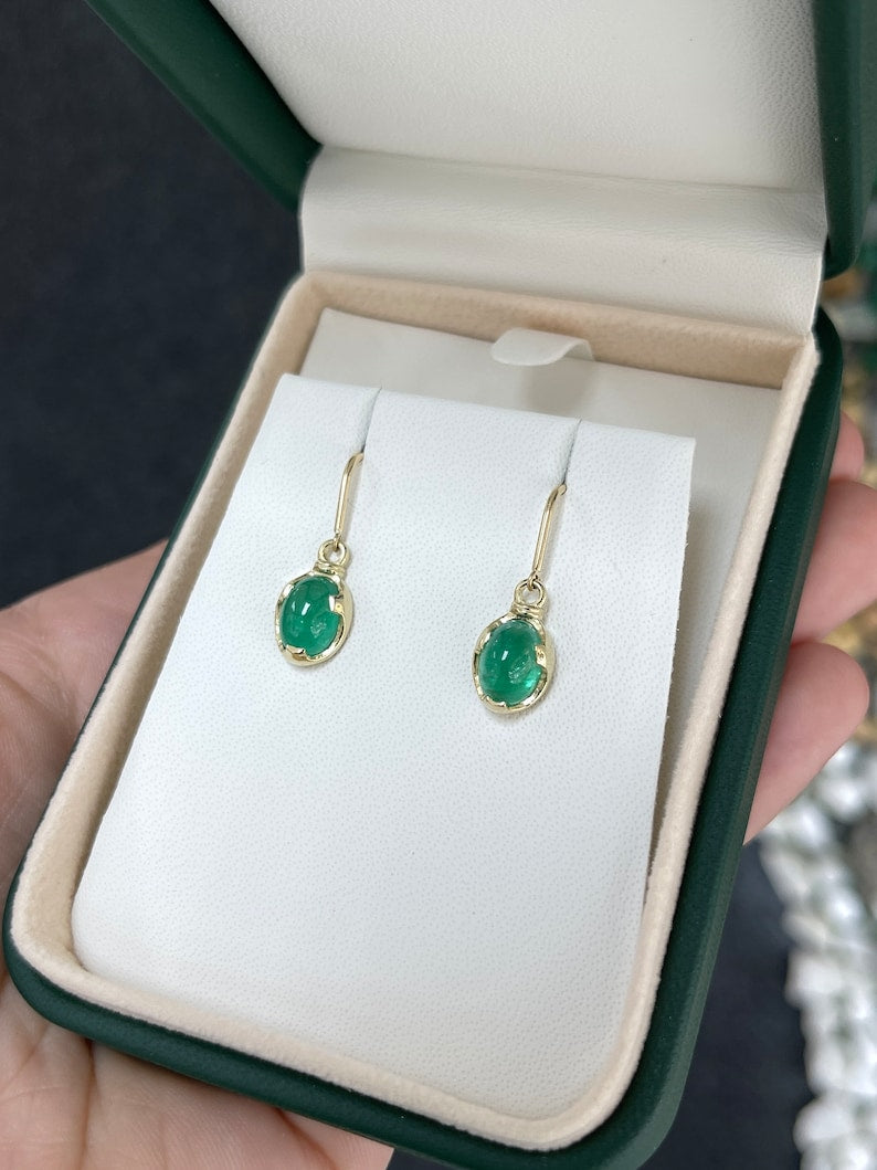 Colombian Emerald earrings with 3.60tcw oval cabochon cut emeralds in 14K gold dangle ear wires.