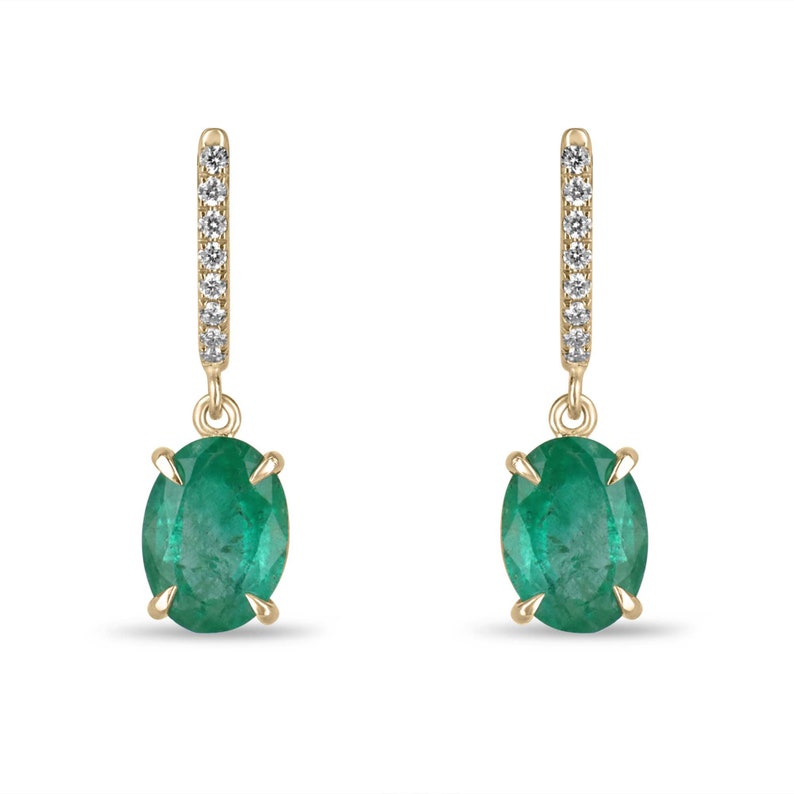 14K gold huggie dangle earrings featuring oval cut dark green emerald and diamond accents by Colombian Emerald.