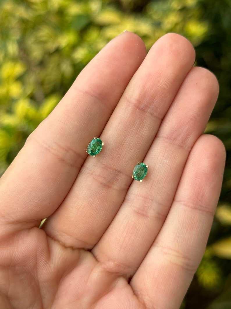 Colombian Emerald 0.80tcw 14K gold petite oval cut four-prong children’s earrings featuring rich green emeralds