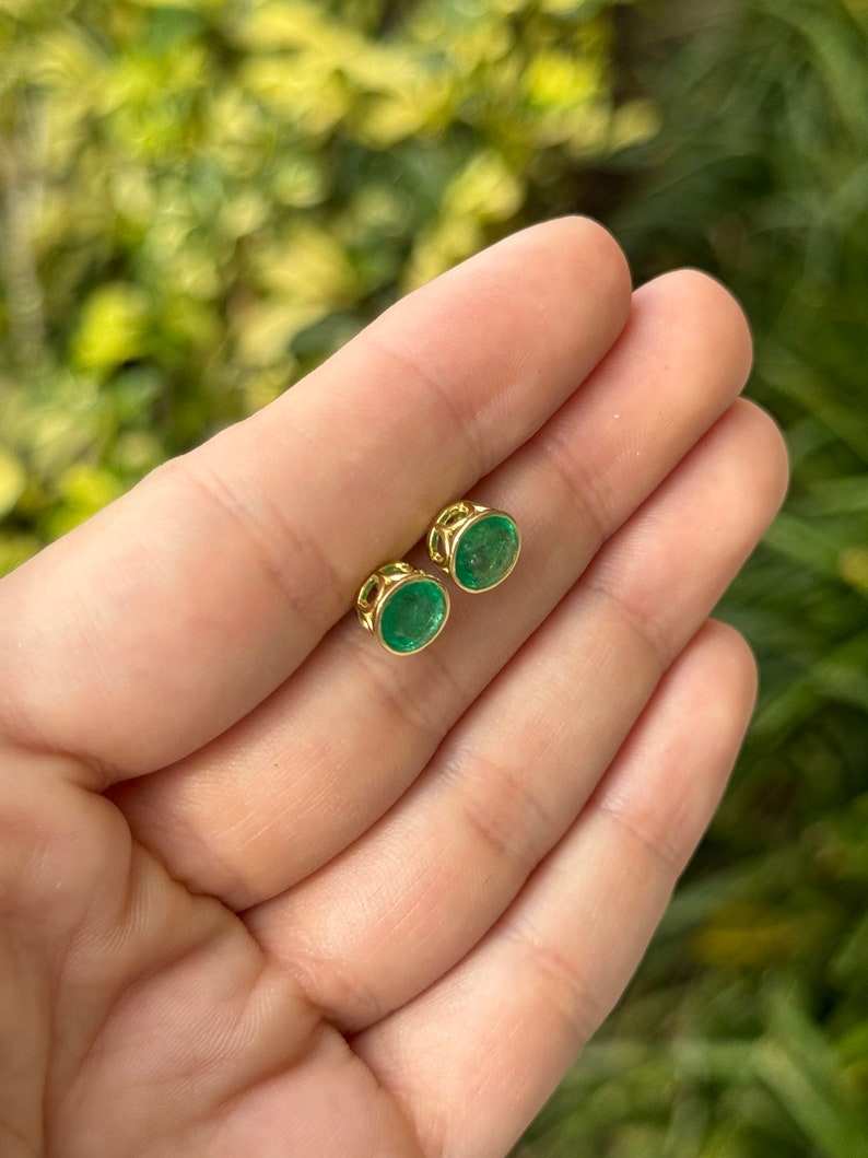 Colombian Emerald 2.14tcw 18K gold round cut green bezel set with Windows emerald stud earrings, showcasing vibrant gemstones.