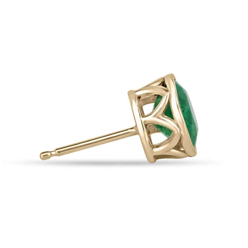 Colombian Emerald green bezel-set stud earrings featuring round cut vivid rich green emeralds and window accents in 18K gold.