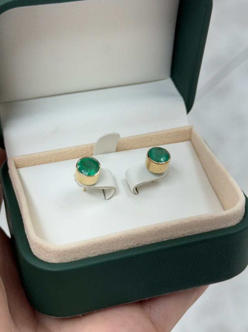 14K natural lush green emerald stud earrings, 2.82tcw, round cut, unisex jewelry by Colombian Emerald, shown in close-up image.