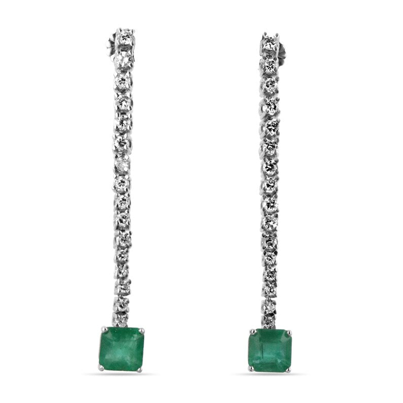Colombian Emerald 3.0tcw 14K white gold dangle earrings with dark green asscher cut emeralds and sparkling diamonds.