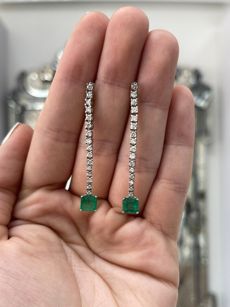 14K white gold emerald and diamond dangle earrings featuring lush dark green asscher cut emeralds and sparkling diamonds from Colombian Emerald