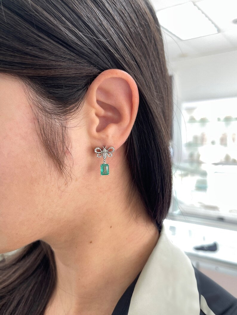 14K gold emerald and diamond butterfly dangle earrings with pave accents, featuring lush medium green Colombian emeralds.