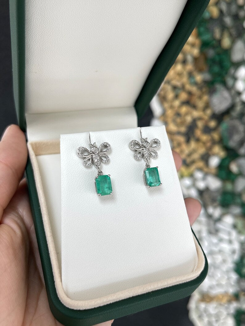 14K gold emerald and diamond butterfly dangle earrings featuring medium green emeralds and pave diamonds by Colombian Emerald