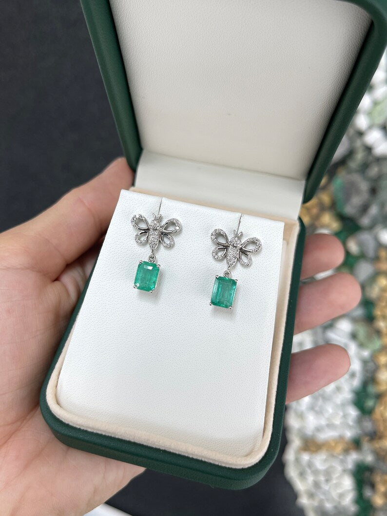 Colombian Emerald 14K gold butterfly dangle earrings with medium green emeralds and pave diamonds, elegant jewelry accessory.