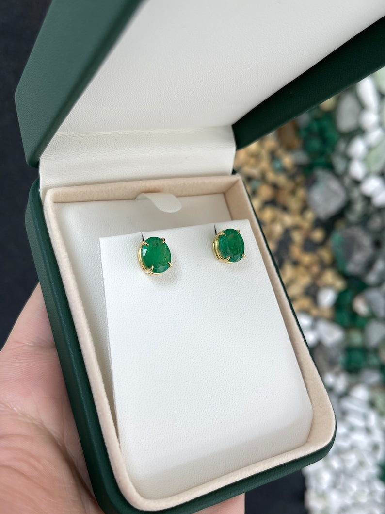 Colombian Emerald 4.85tcw 18K gold oval cut dark green stud earrings with four prong claw setting