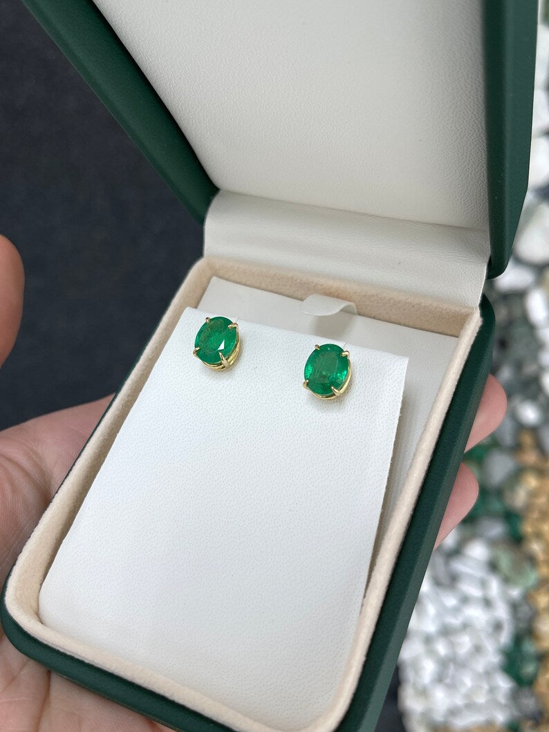 Colombian Emerald 4.85tcw 18K gold oval cut dark green stud earrings with four prong claw settings