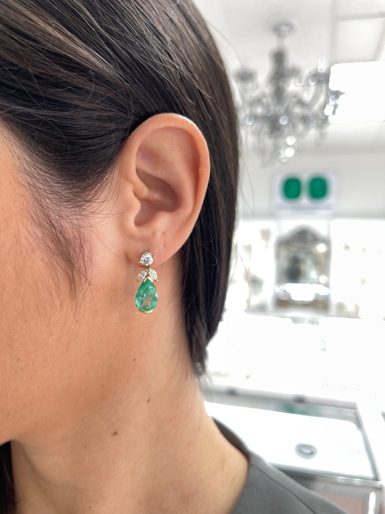Colombian Emerald 7.97tcw 18K gold pear cut green teardrop emerald and marquise diamond floral earring jackets.