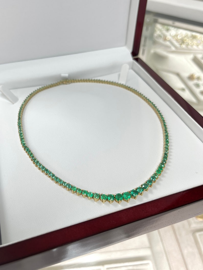 Colombian Emerald tennis necklace with 22.0 tcw vivid medium dark green round emeralds on 14K yellow gold chain.