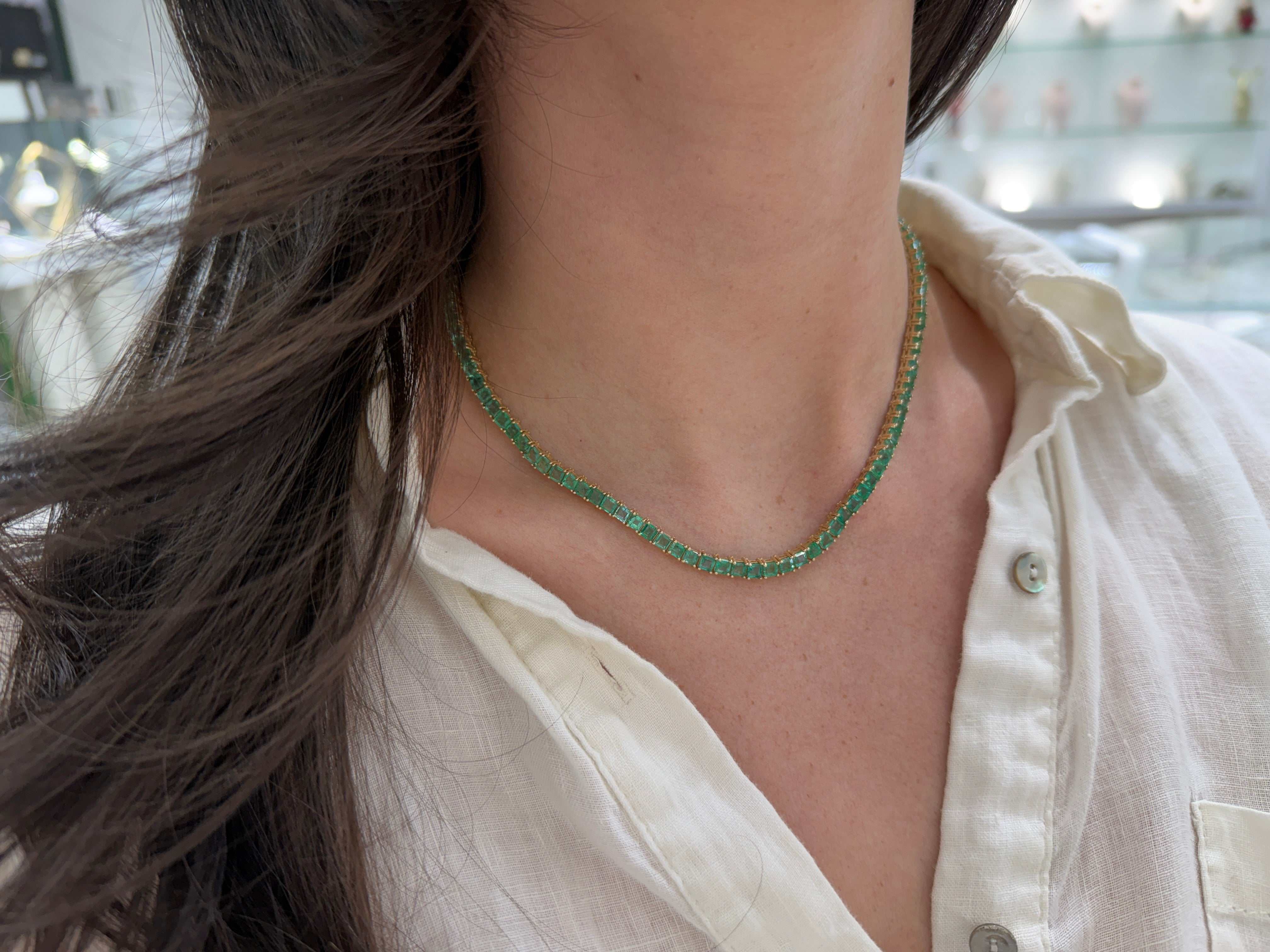 Colombian Emerald 19-inch adjustable princess cut pendant necklace in 14K gold, featuring a vibrant emerald gemstone.