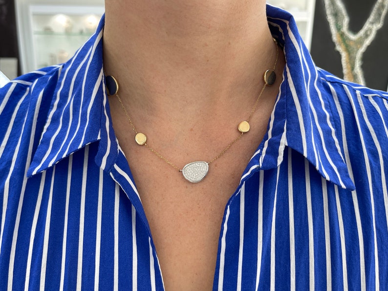 14K white and yellow gold diamond cluster emerald necklace with a semi-circle cable chain, featuring brilliant round-cut diamonds.