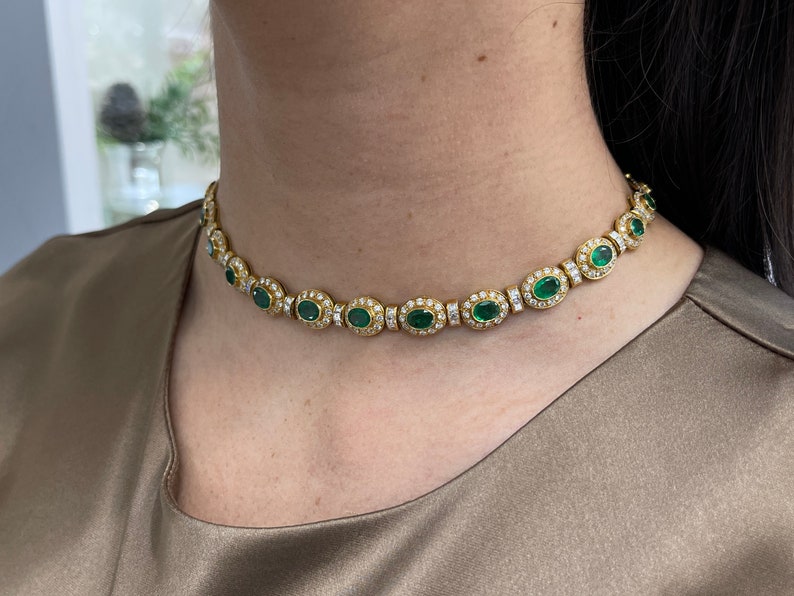 Colombian Emerald 18K gold choker necklace with vivid green oval-cut emerald and diamond accents, elegant jewelry piece.
