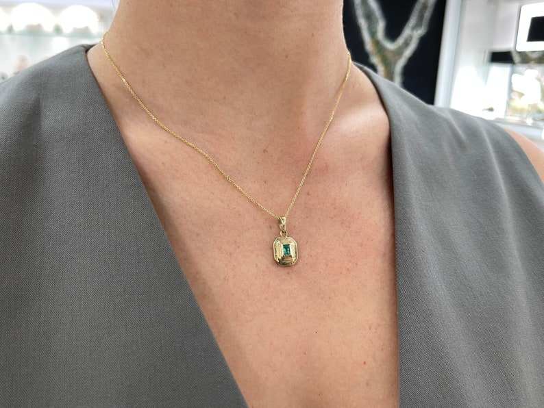14K gold unisex pendant necklace featuring a 0.40ct natural North-to-South emerald cut Colombian emerald bezel set.