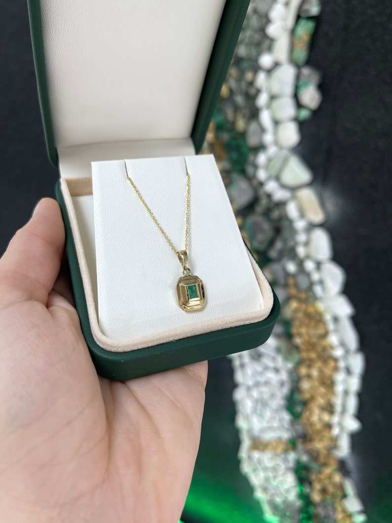 14K gold unisex pendant necklace featuring a 0.40ct lush green natural North-South emerald cut bezel set by Colombian Emerald.