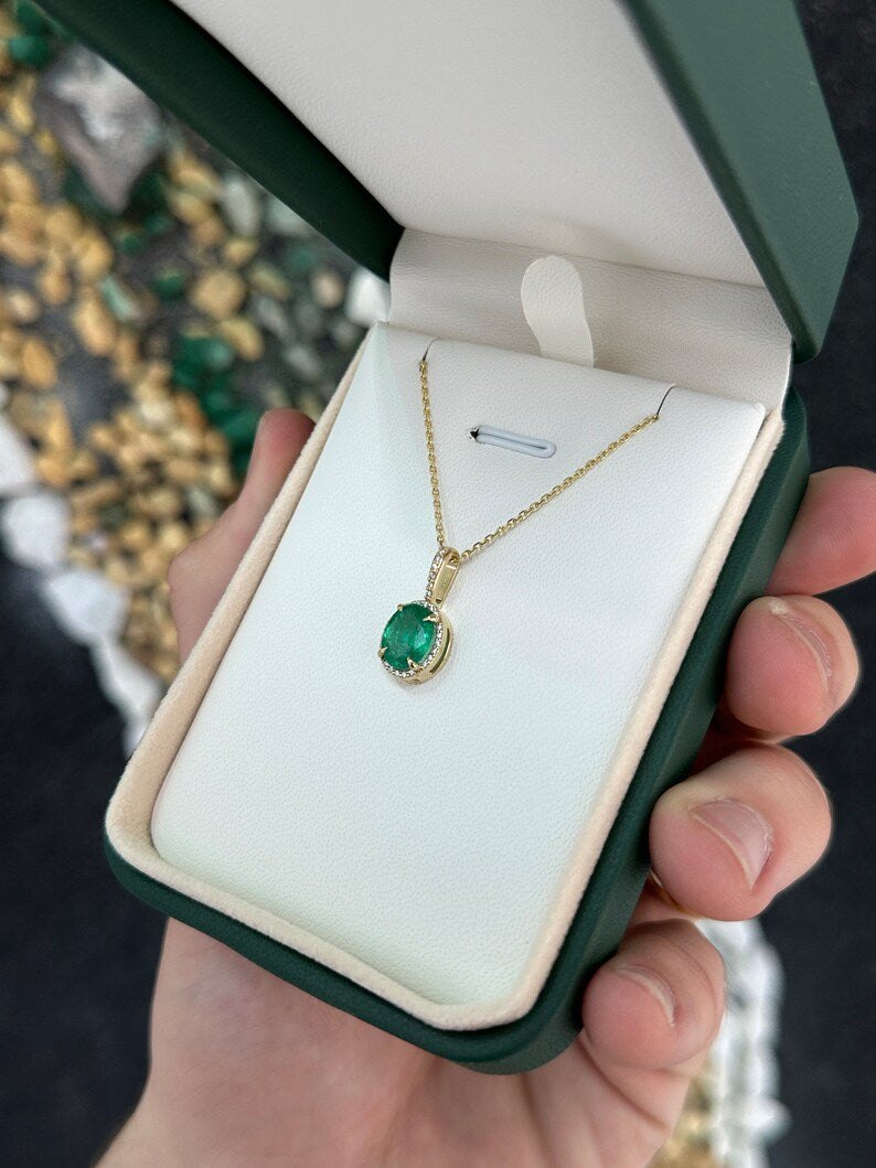 Deep green oval emerald pendant with diamond halo, 14K gold Colombian Emerald necklace, showcasing elegant jewelry design.