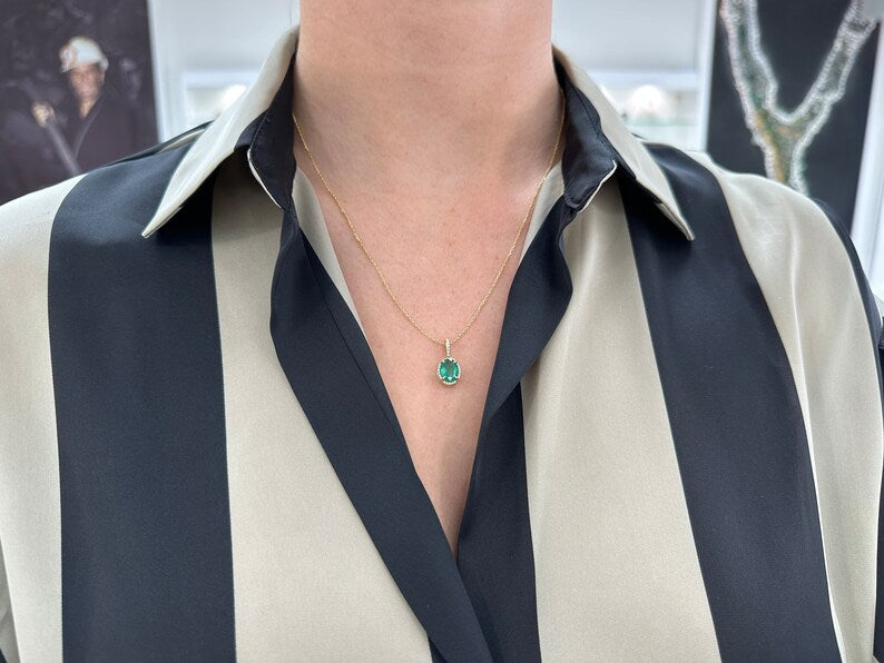Deep green oval emerald pendant with diamond halo, 14K gold Colombian Emerald necklace, elegant jewelry with sparkling accents.