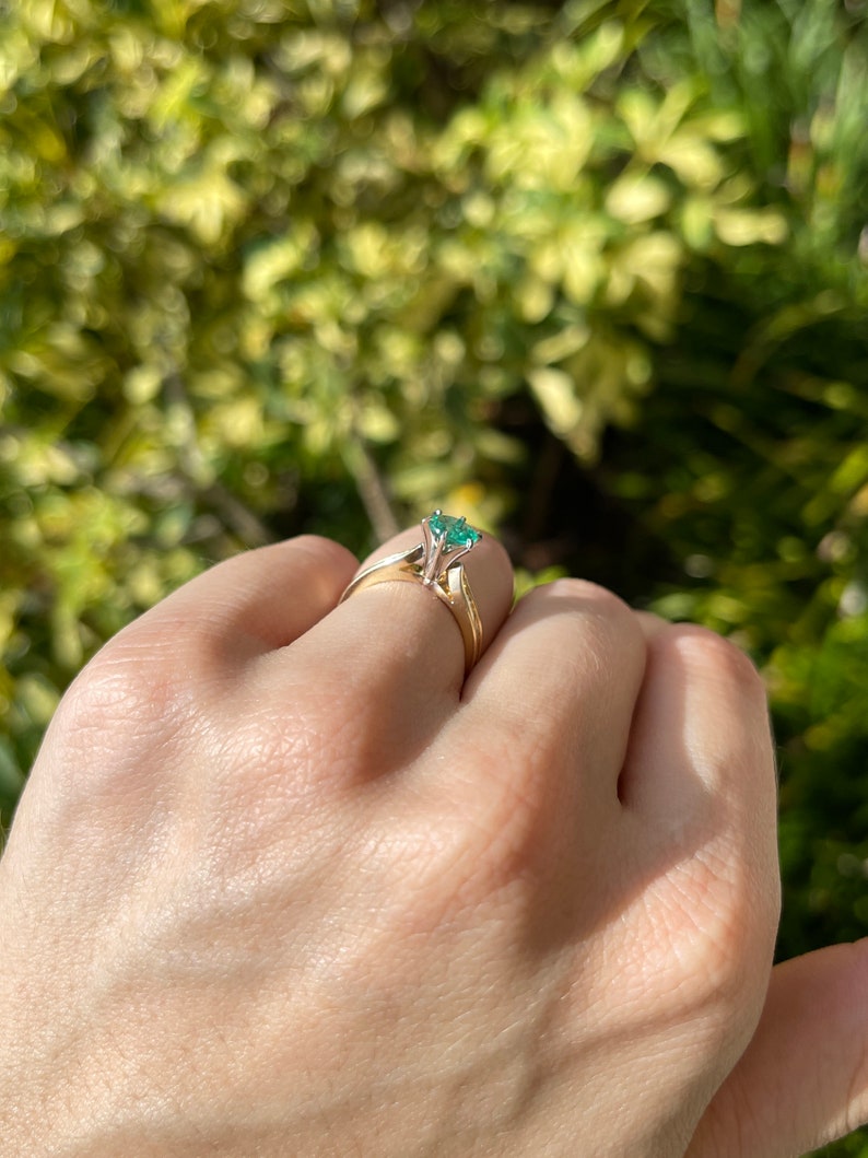 Colombian Emerald two-tone 14K engagement ring with round-cut diamond accents and six-prong setting.