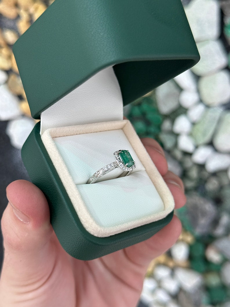 Vintage-inspired emerald cut engagement ring with diamond accents in 14K gold, featuring floral design and Colombian emerald brand.
