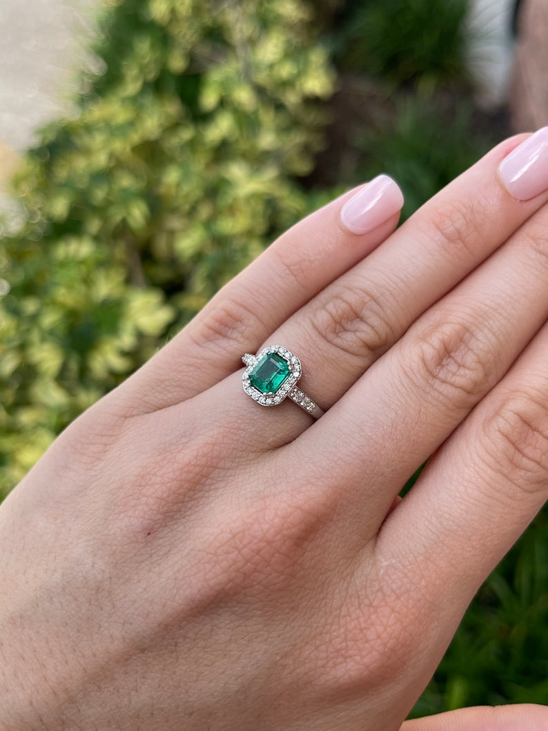High-quality Zambian emerald cut emerald and diamond halo engagement ring in 14K gold by Colombian Emerald.