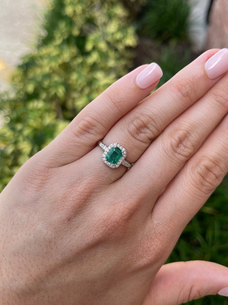 High-quality Zambian emerald cut emerald and diamond halo engagement ring in 14K gold by Colombian Emerald.