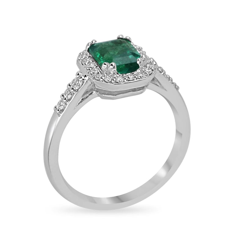 High-quality Zambian emerald-cut emerald and diamond halo engagement ring in 14K gold from Colombian Emerald.