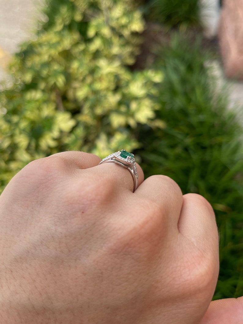 High-quality Zambian emerald cut emerald and diamond halo engagement ring in 14K gold by Colombian Emerald.