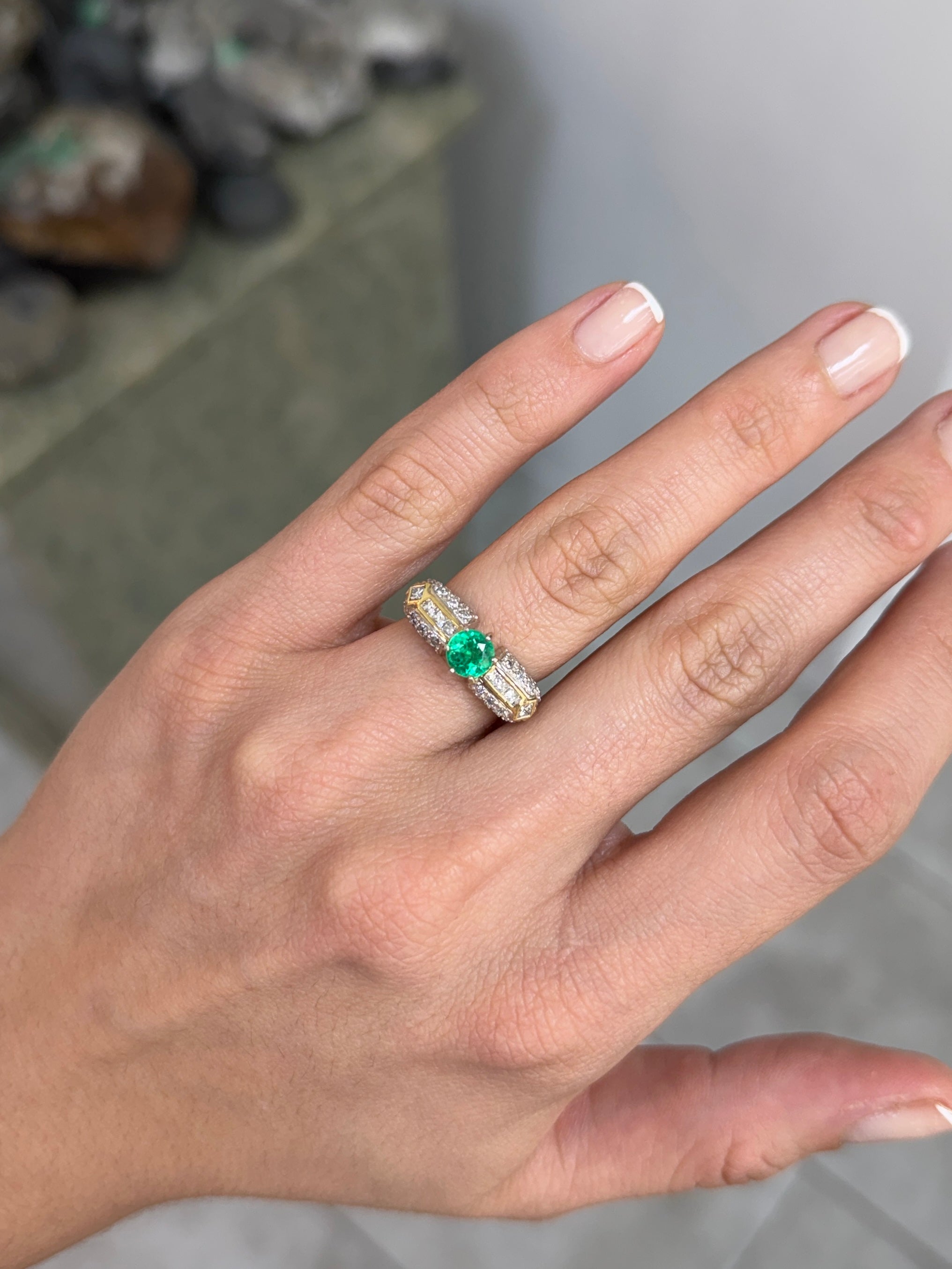 18K gold engagement ring with 1.85tcw round cut Colombian emerald and diamond accents, showcasing elegant jewelry design.