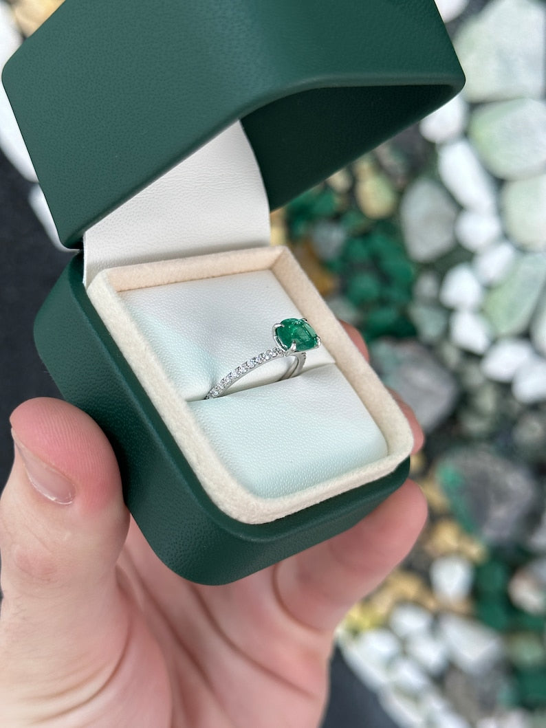 14K gold engagement ring with 1.60tcw East to West Zambian emerald and diamond accents, showcasing elegant craftsmanship.