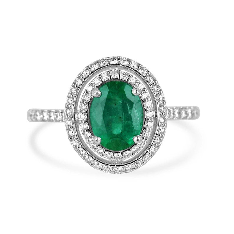 Colombian Emerald engagement ring with 1.90tcw lush green oval-cut emerald and double diamond halo in 14K gold.