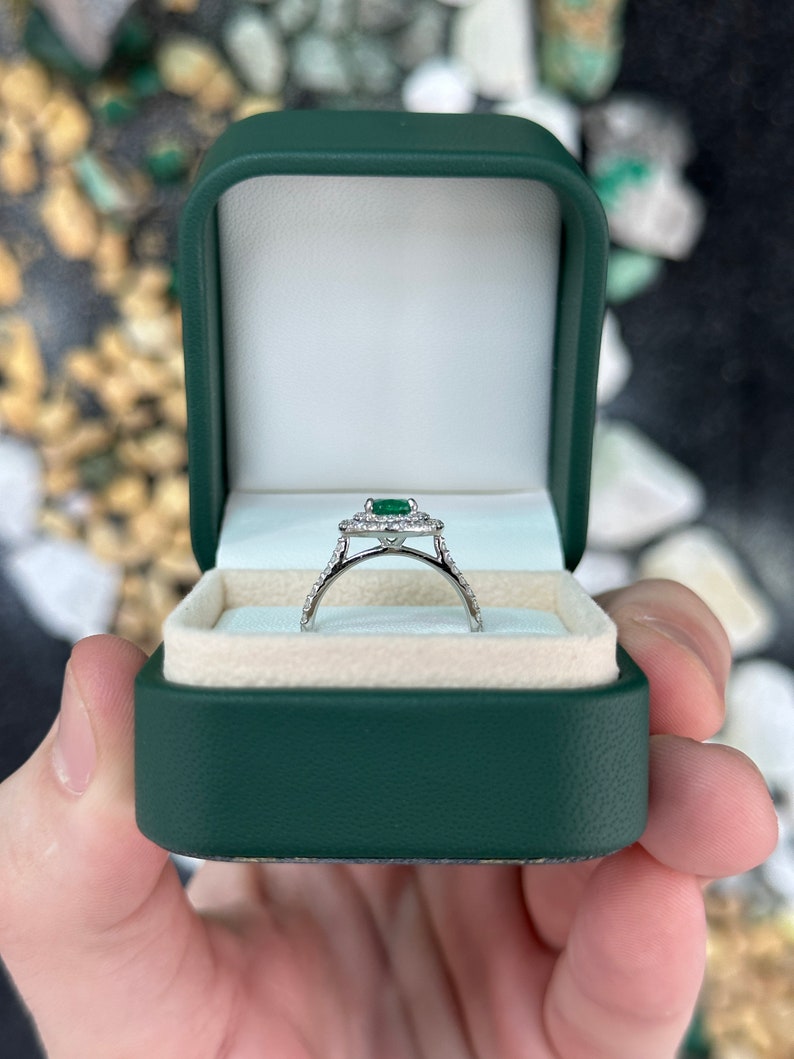 Colombian Emerald 8x6 oval cut engagement ring with double diamond halo in 14K white gold, featuring lush green gemstone.