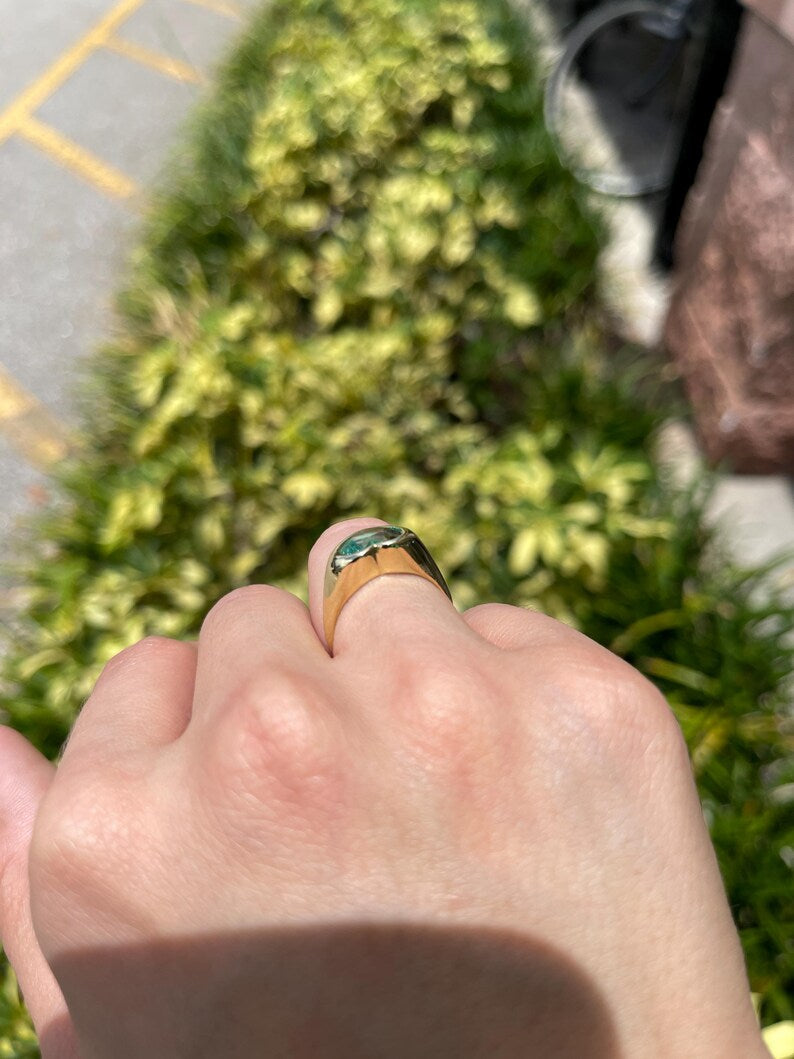 18K gold unisex engagement ring with heart-cut Colombian emerald bezel setting, featuring a 2.19ct emerald for Nabil and Tara.