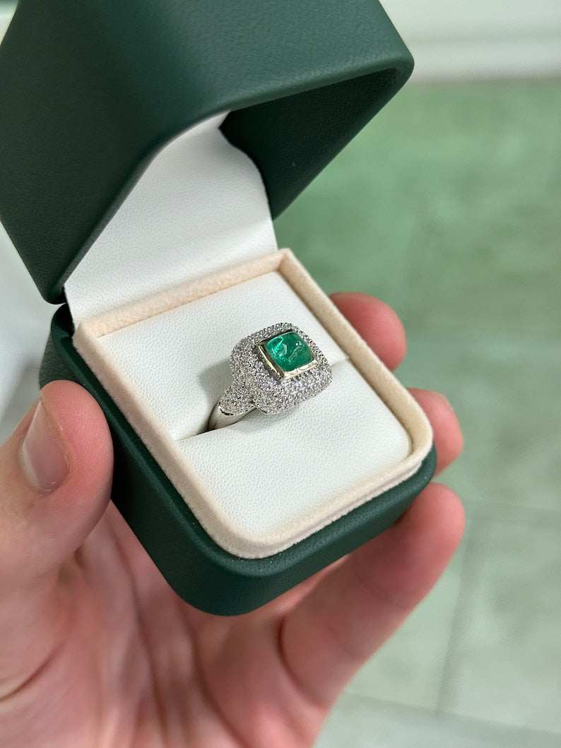 Natural Colombian emerald cluster engagement ring with diamond accents in 14K gold, featuring a sugarloaf cut emerald centerpiece.