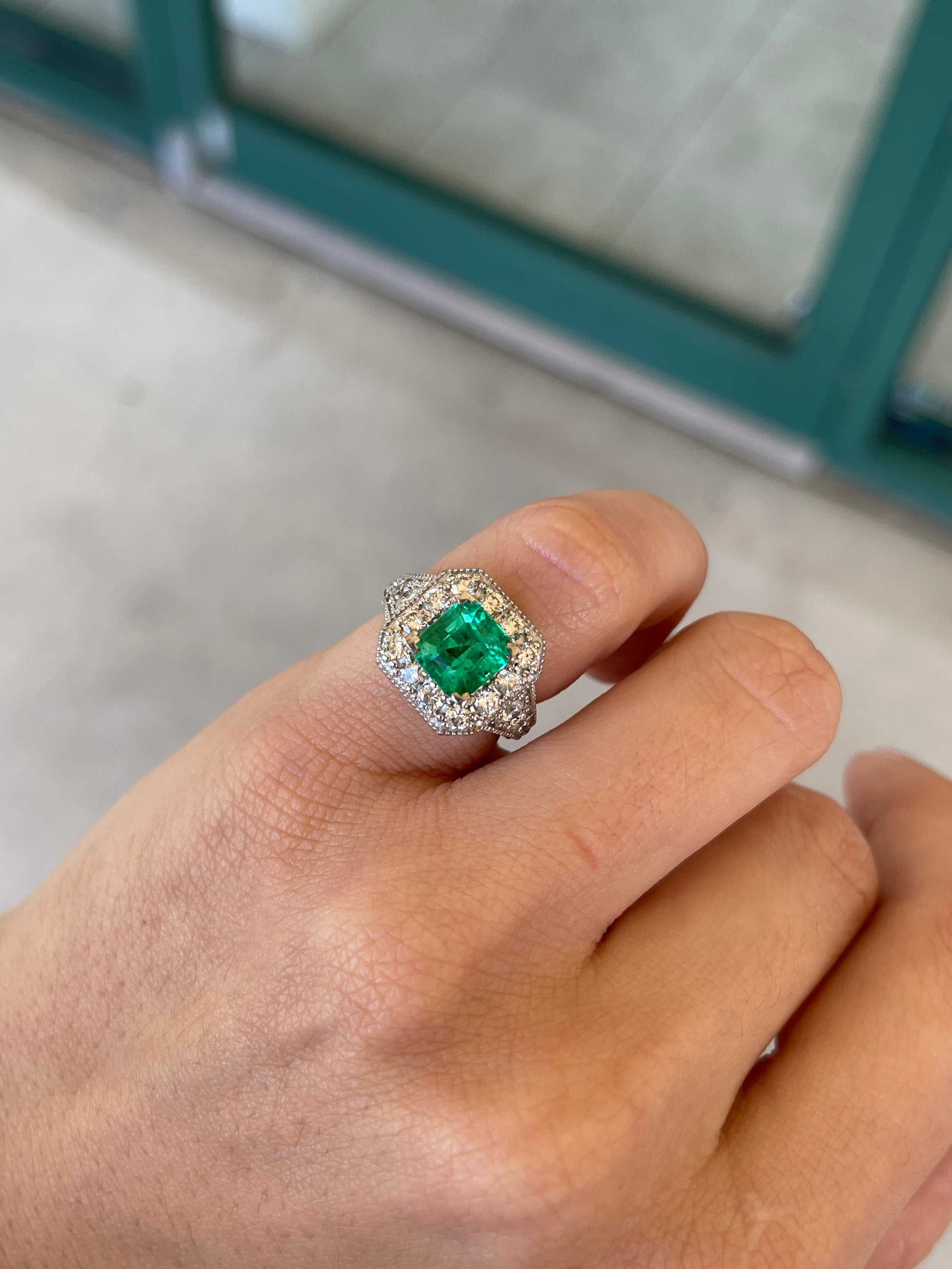 Colombian Emerald 14K engagement ring with 3.08tcw AAA vivid green emerald cut diamond halo accent ring displayed.