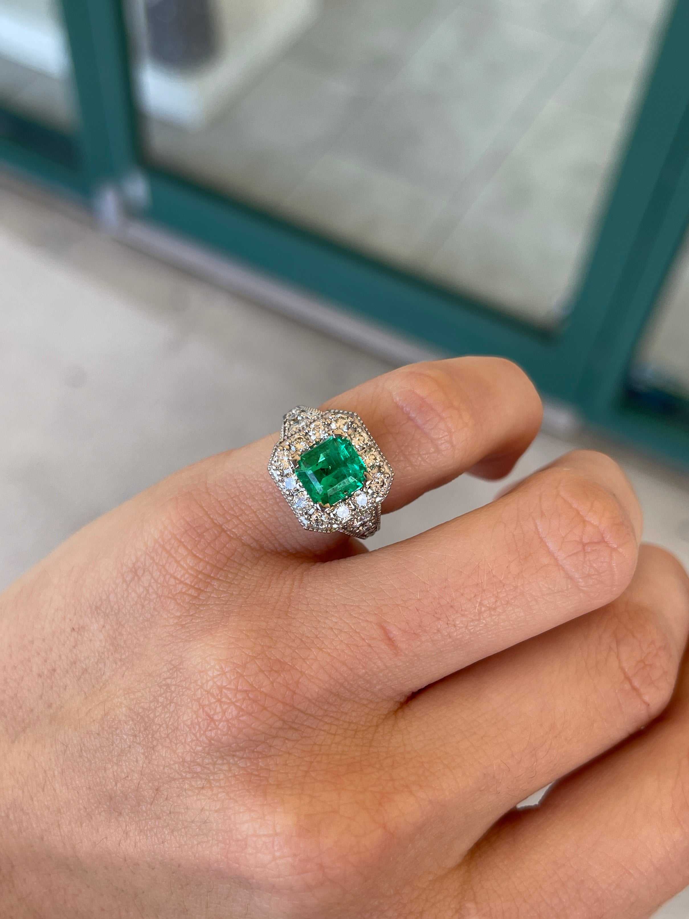 Colombian Emerald AAA green diamond halo engagement ring with emerald cut center stone in 14K gold, featuring intricate detailing.