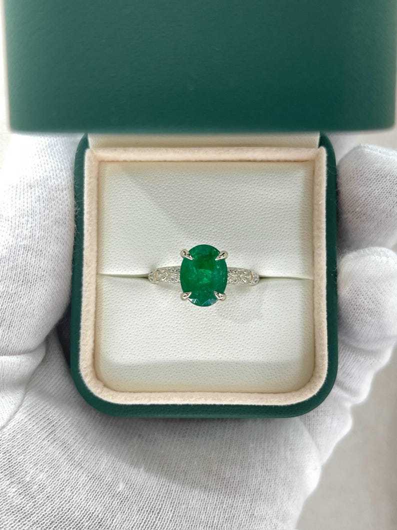 14K white gold engagement ring featuring a 3.11ct dark green oval emerald solitaire from Colombian Emerald.