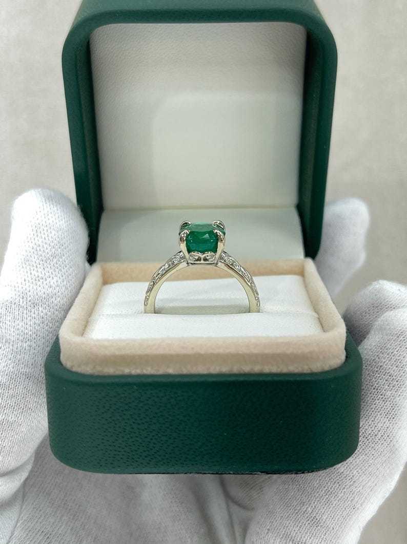 14K white gold engagement ring featuring a 3.11ct dark green oval emerald solitaire from Colombian Emerald.