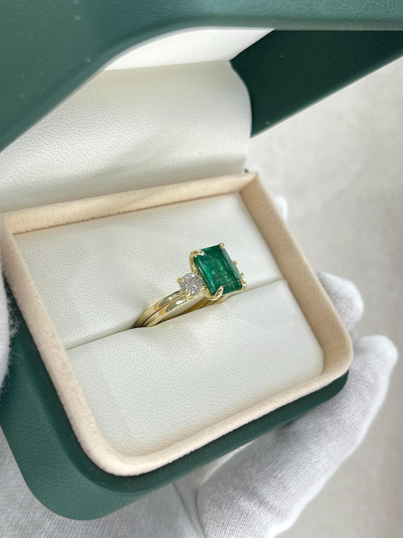 14K natural emerald and diamond convertible three-stone engagement ring with Colombian Emerald branding, showcasing the intricate design.