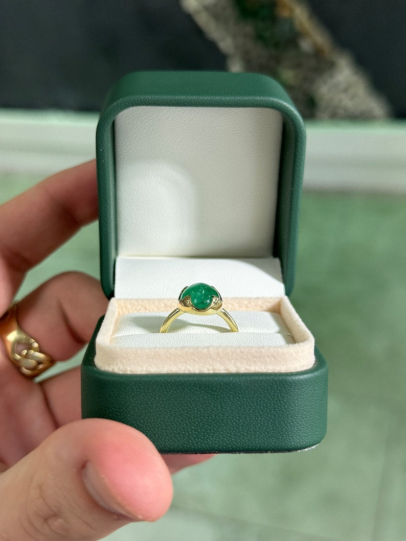 14K gold engagement ring featuring a 4.29ct dark green oval cabochon emerald solitaire from Colombian Emerald.