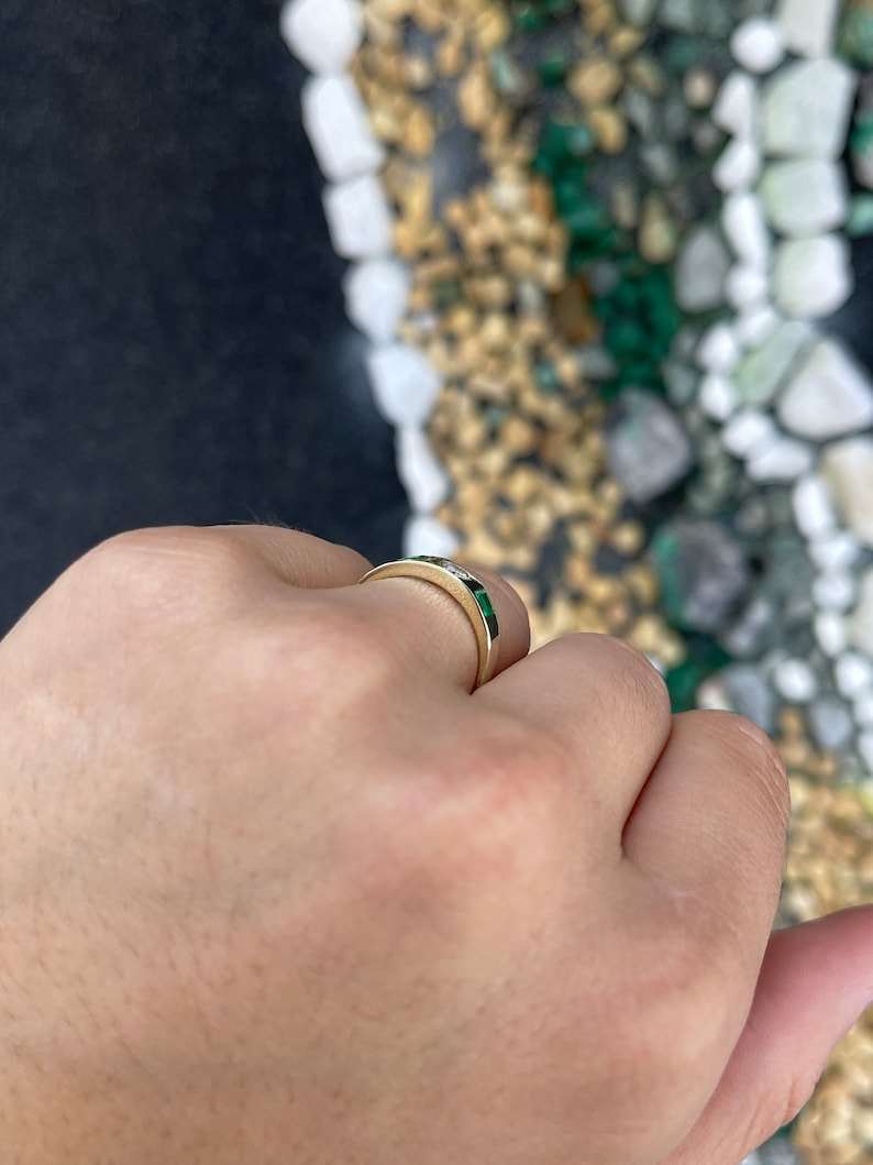 Ladies emerald ring featuring a 0.60tcw vivid green princess and round cut diamonds in a 14K gold 3-stone band by Colombian Emerald.