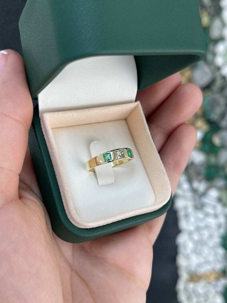 Ladies emerald ring featuring a 0.68tcw vivid green diamond and emerald princess cut band in 14K gold by Colombian Emerald.