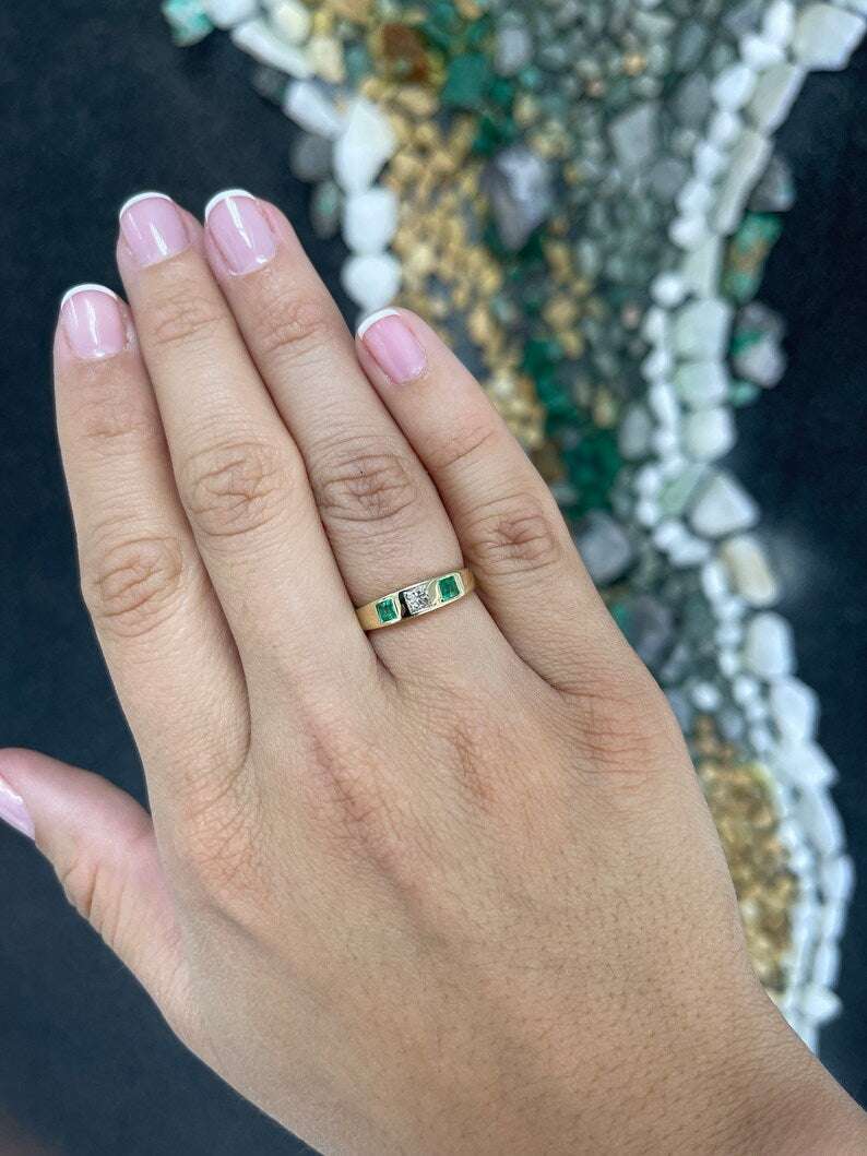 Ladies emerald ring featuring a 0.68 tcw medium vivid green diamond and emerald princess cut band in 14K gold by Colombian Emerald.